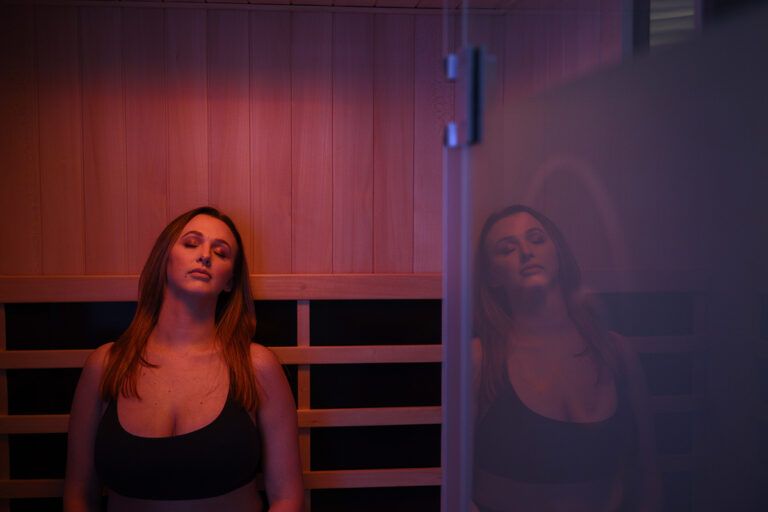 Woman inside an infrared sauna for halotherapy